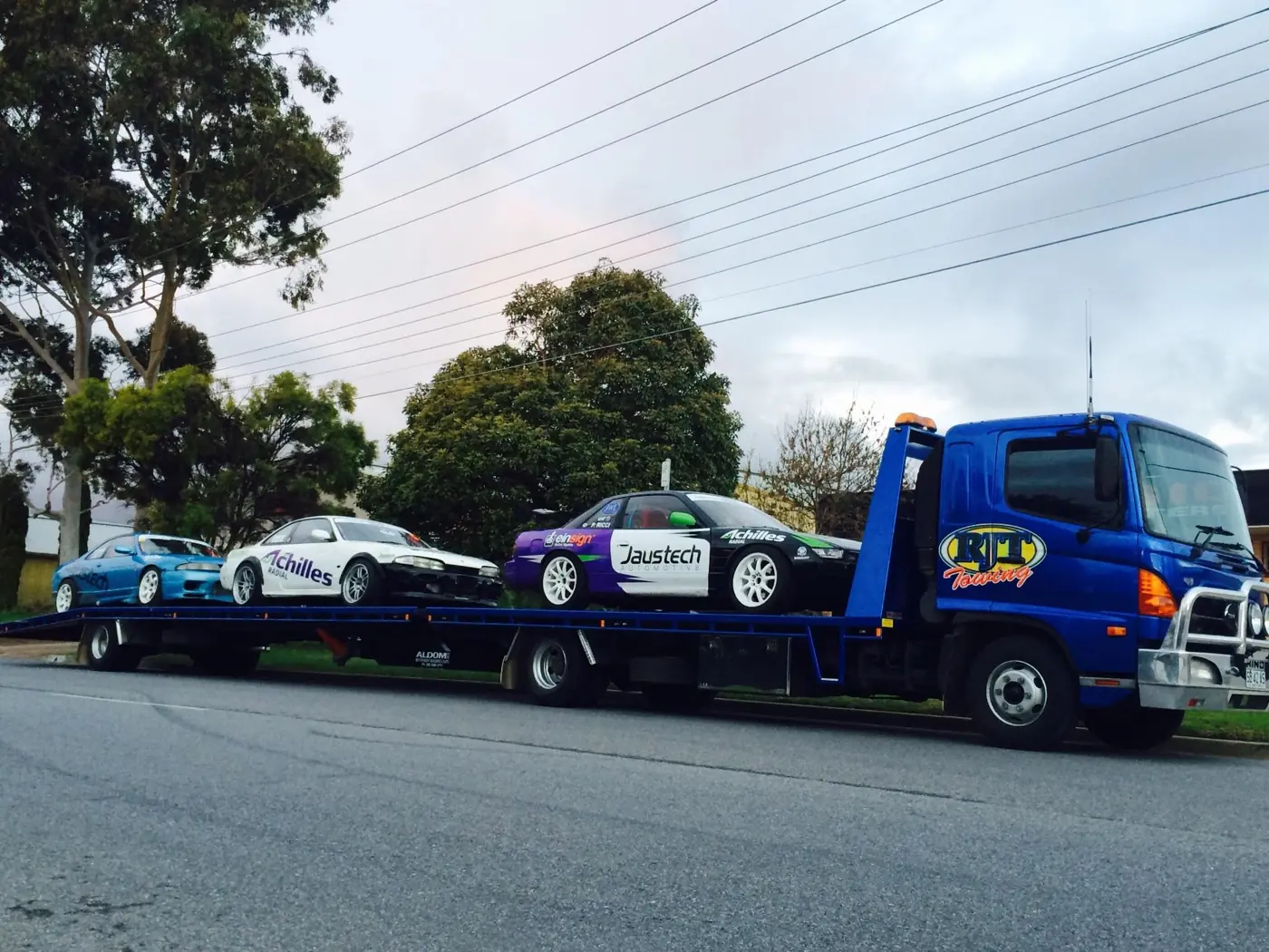 RJT Towing loading a 20ft shipping container onto the tilt-tray